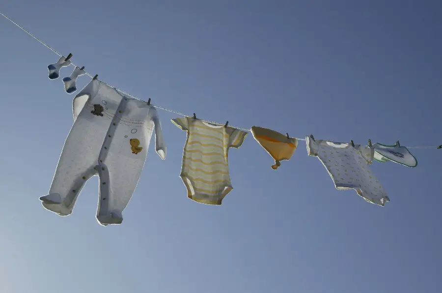 Baby and baby clothes photo on a rope