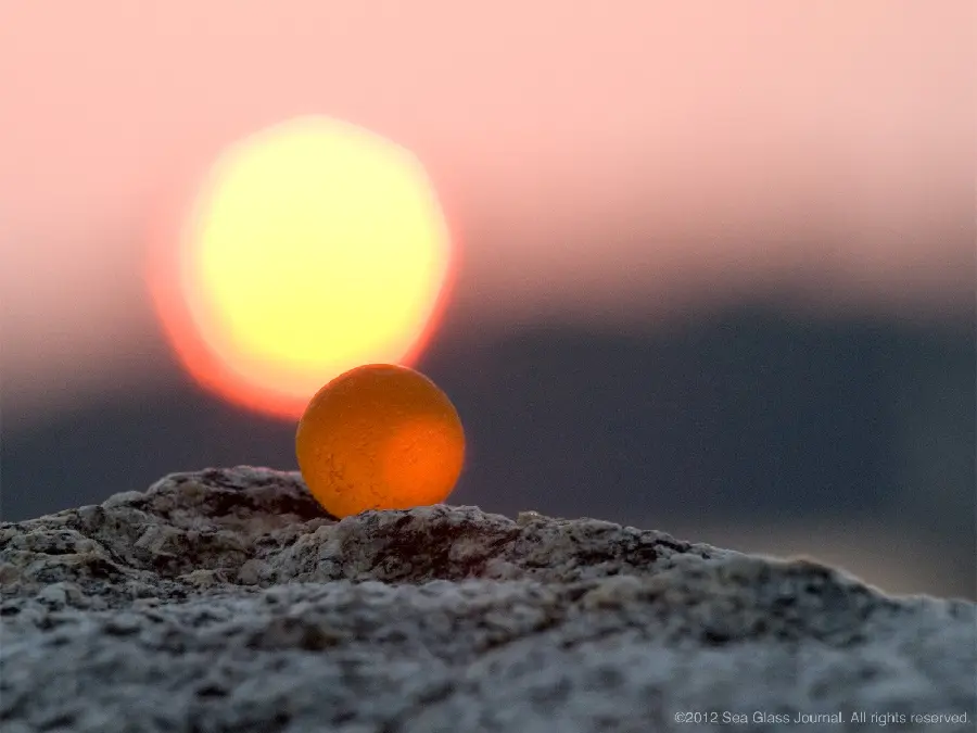Photo of Orange Sea Glass Stone at Clear Sunset