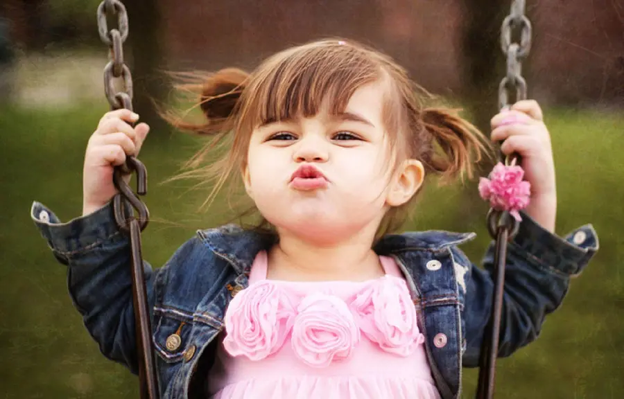 Cute and beautiful baby girl photo playing top