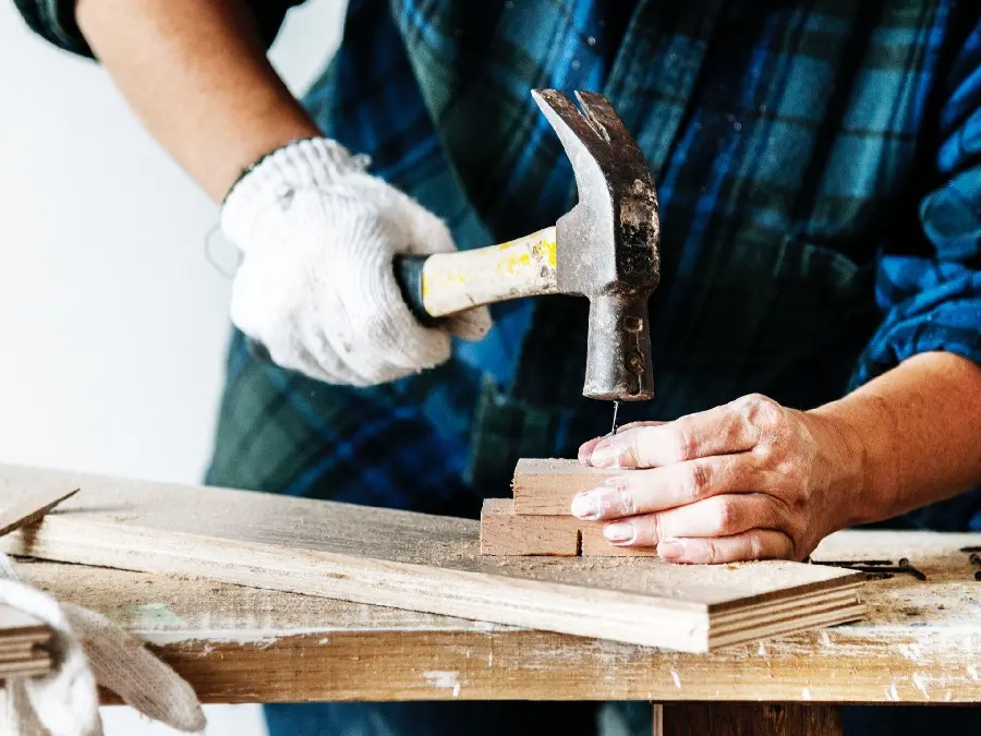 Profile photo of a carpenter working with a hammer and nails