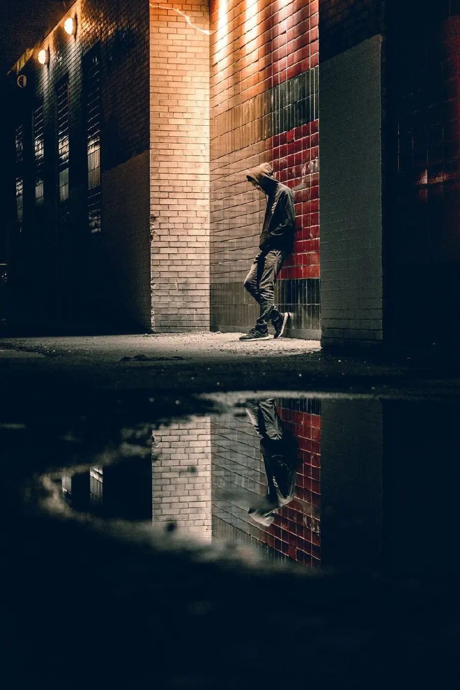 Lonely Boy Photo Image Next to the Building and leaning on the wall