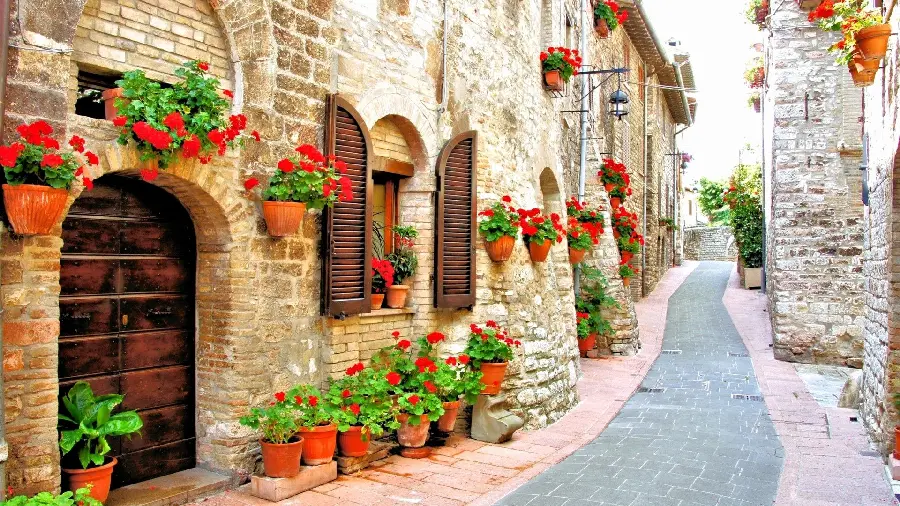 High quality wallpaper of an Italian street with flower pots on the wall
