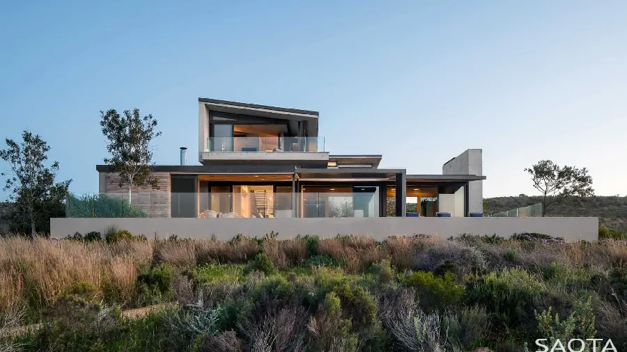 Photo of a stylish and modern villa with a large glass facade