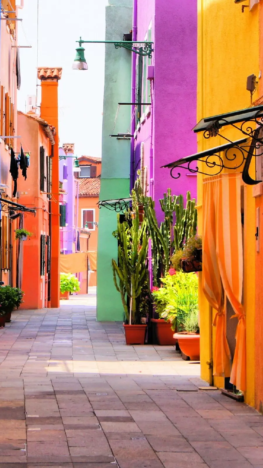 Photo of colorful Italian houses and cobblestone alley