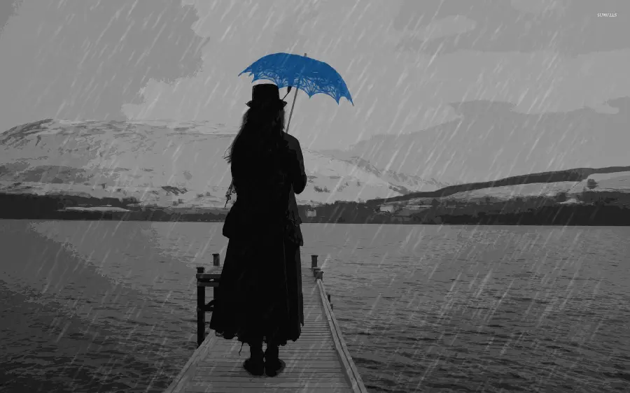 Photo of a blue umbrella and a girl under the rain