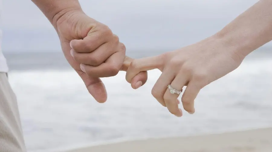 Bride and groom hand in hand wallpaper on the beach
