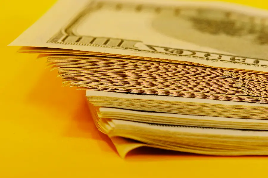 US dollar bills with yellow background