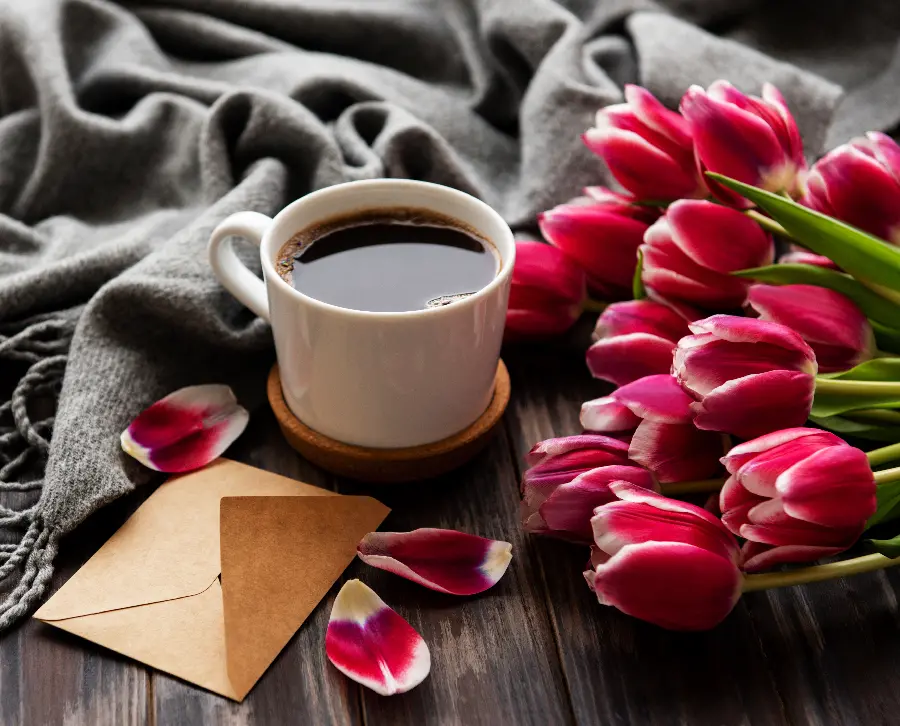 Download spring coffee photo next to purple tulip flowers