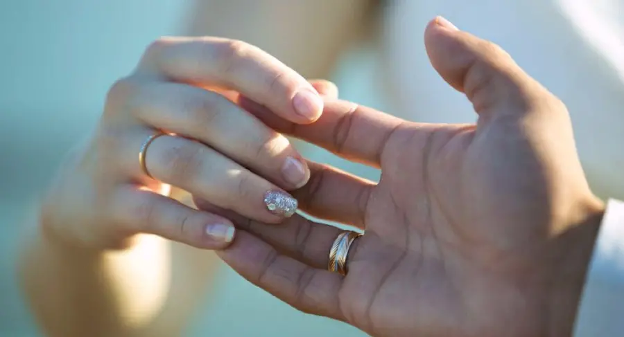 Classy photo of bride and groom pose and wedding rings