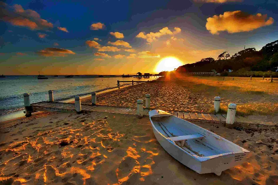 Australian beach with wooden boat for computer and laptop wallpaper