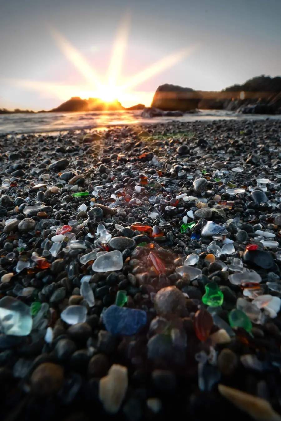 Beach silica stones with different colors and shapes in the sunset transparent colorful