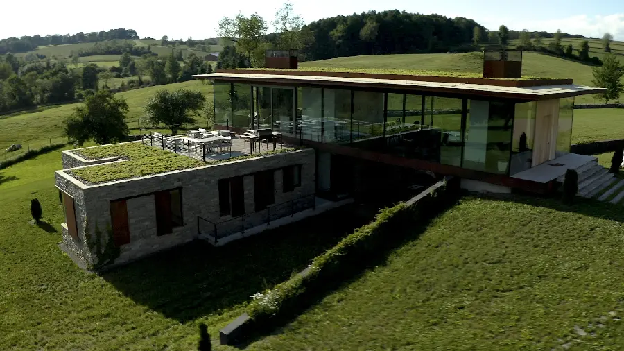 Photo of a green villa building with a glass facade