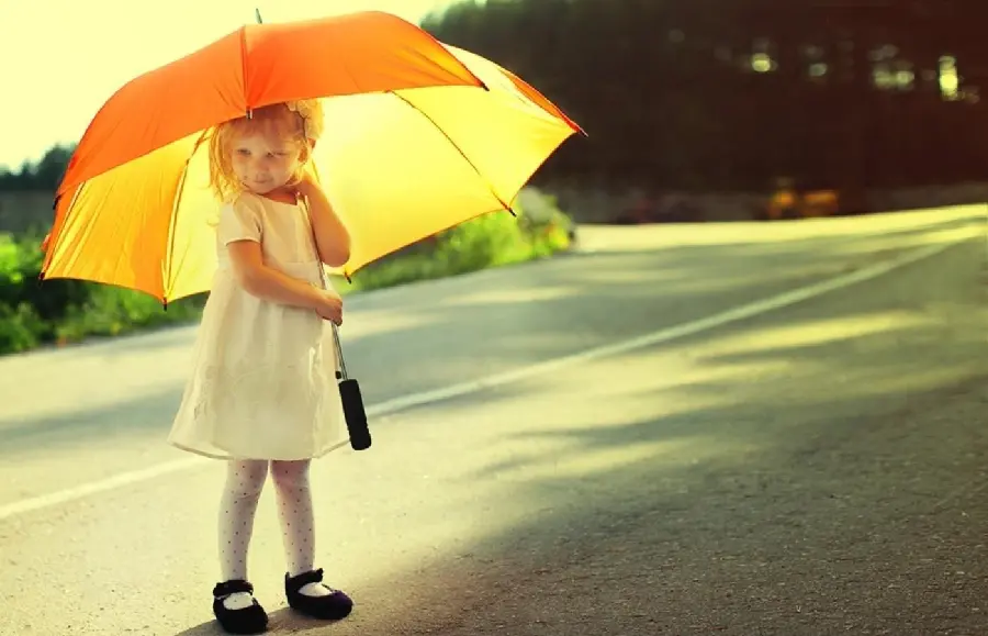 Little girl with umbrella in hand