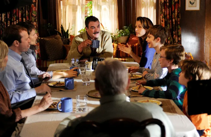 Happy family talking at the dinner table