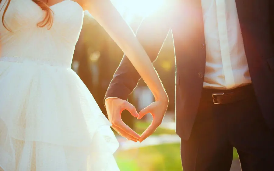 Bride and groom's profile photo with a heart-shaped hand pose