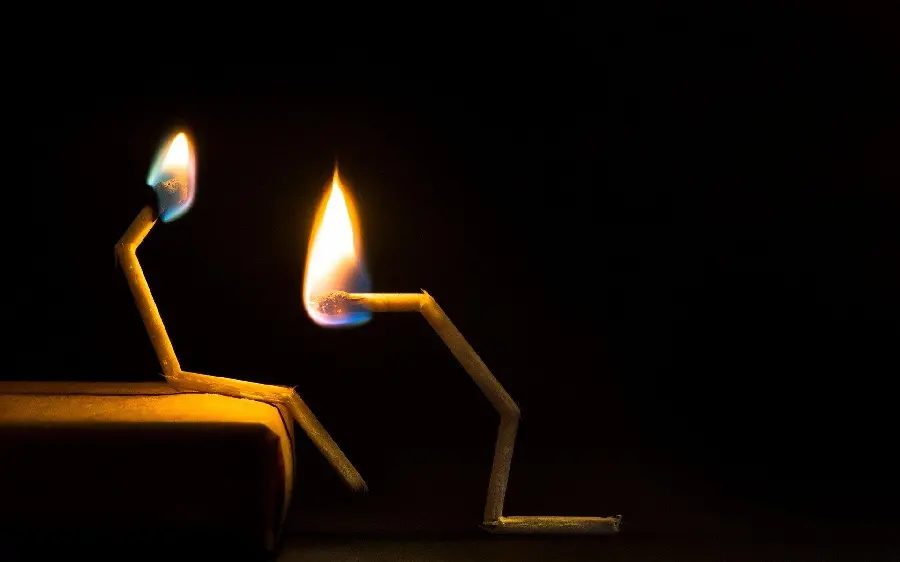 Photo of lit matches of a couple together, romantic and romantic