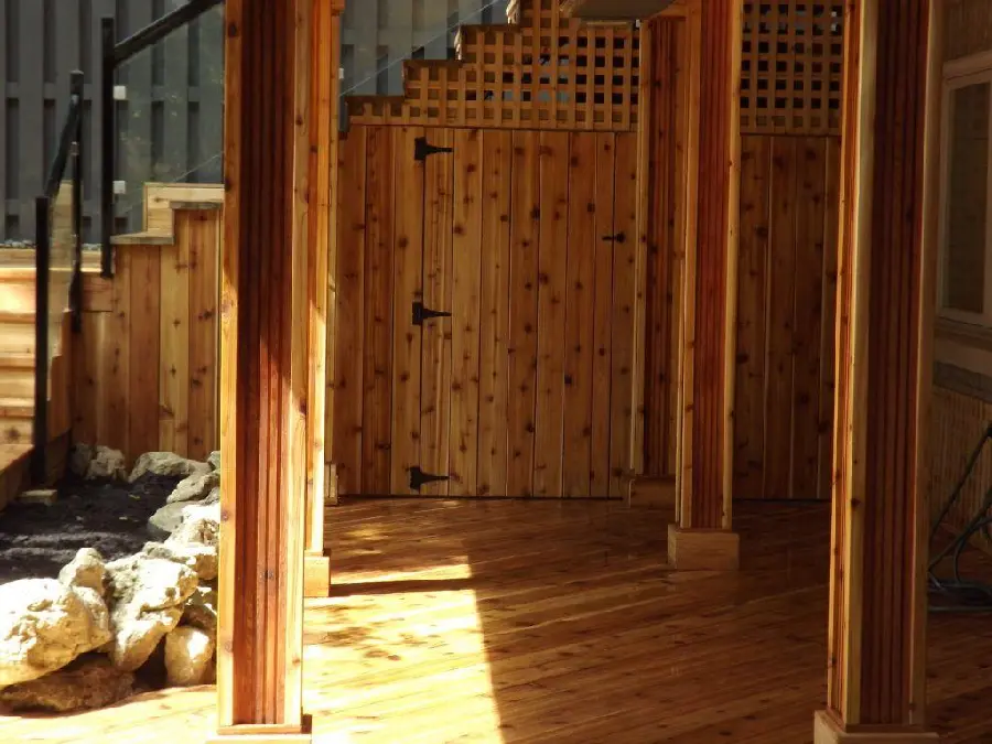 Photo of a wooden house with a staircase and wooden columns