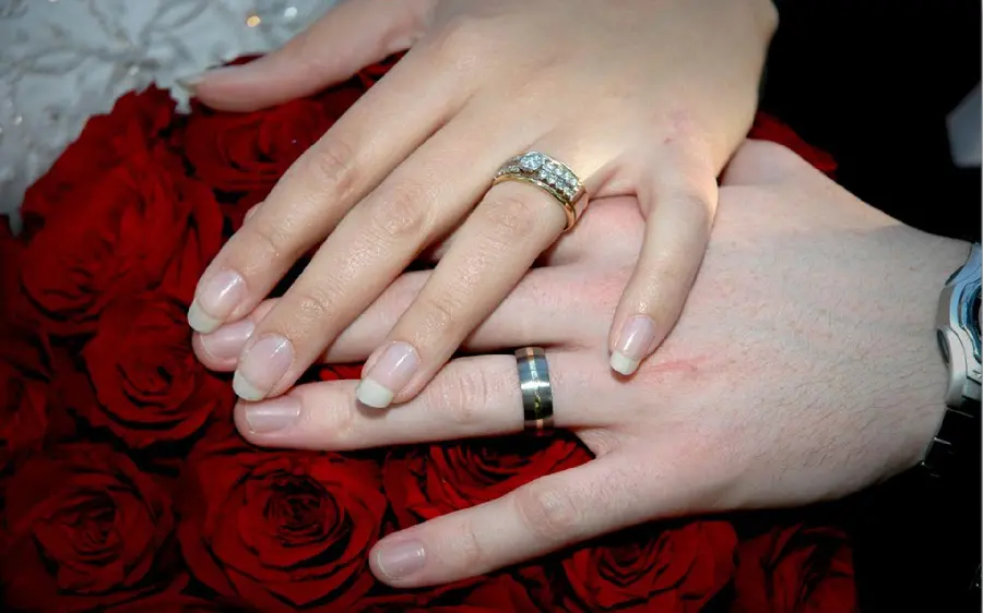 Sample photo of the bride's hand pose and skirt with a ring and a flower hand