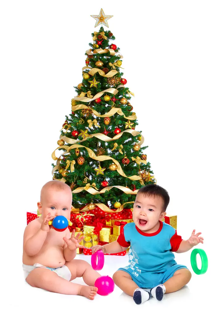 Photo of children next to Santa Claus Christmas tree