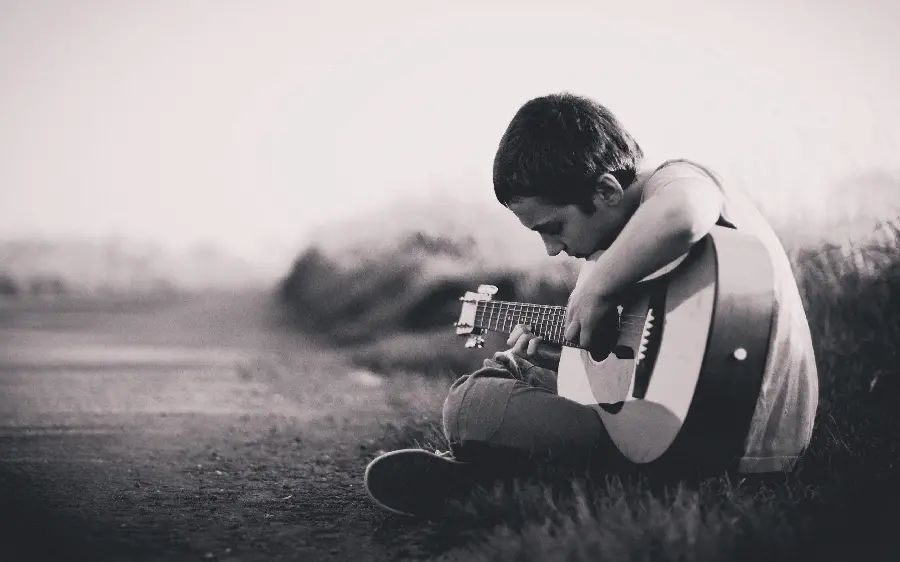Black and White Profile Photo of Lonely Boy with Guitar
