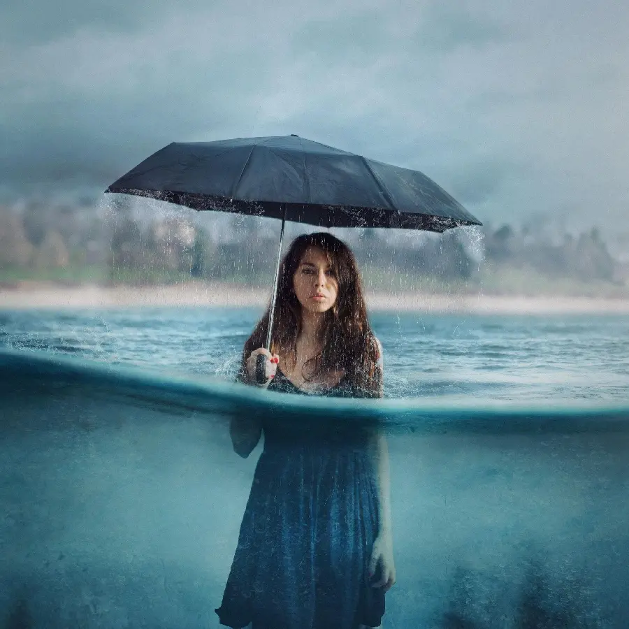 Surreal and realistic photo of a girl in the water with an umbrella in her hand, suitable for a profile