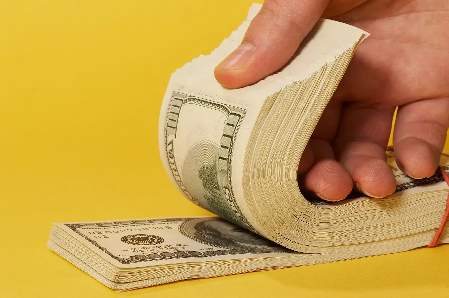 Yellow background of US dollar bills