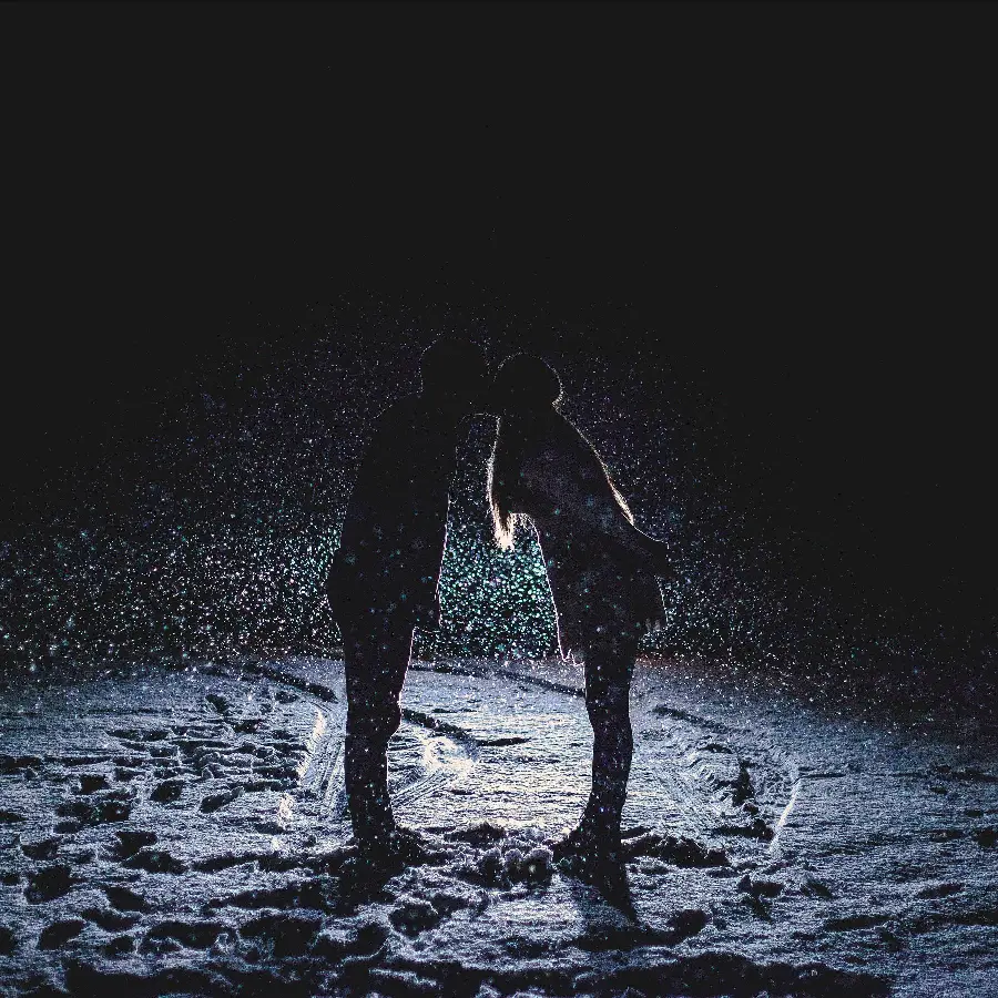 Romantic Wallpaper of Couple Under Romantic Rain on Black Background