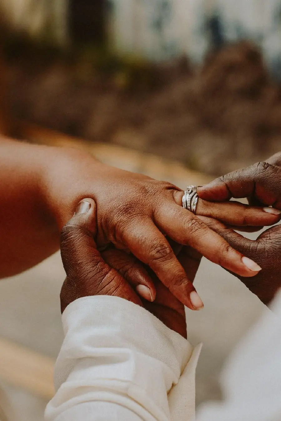 Bride and groom's hands holding rings