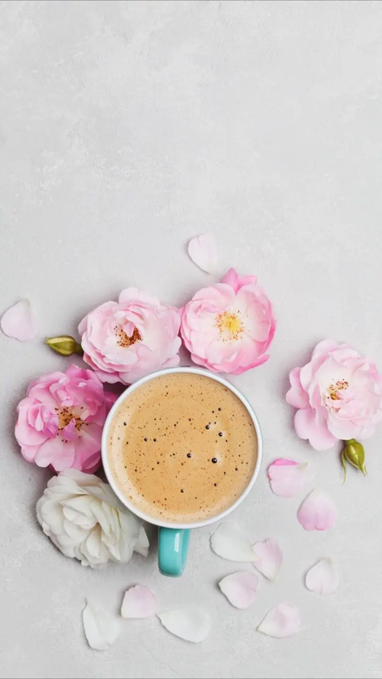 Spring coffee on a white background next to pink flowers