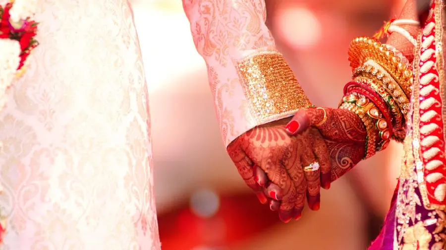 Indian bride's hand pose from the groom's wedding hands