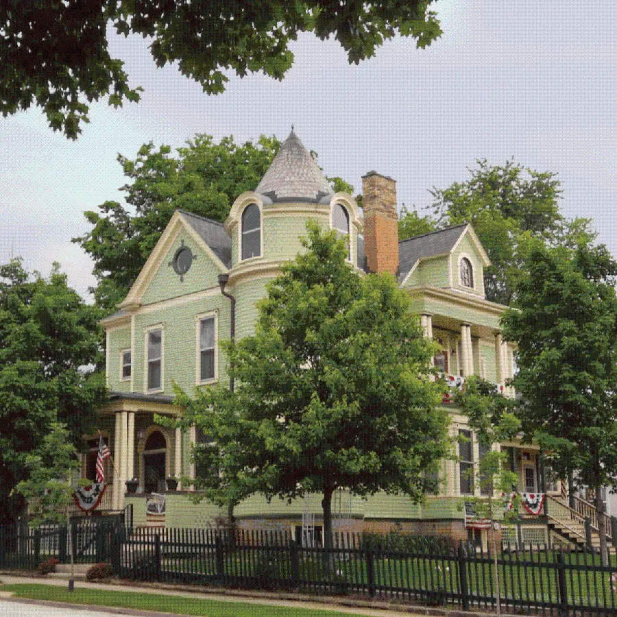 Image of a building with large windows and columns in the Victorian architectural style