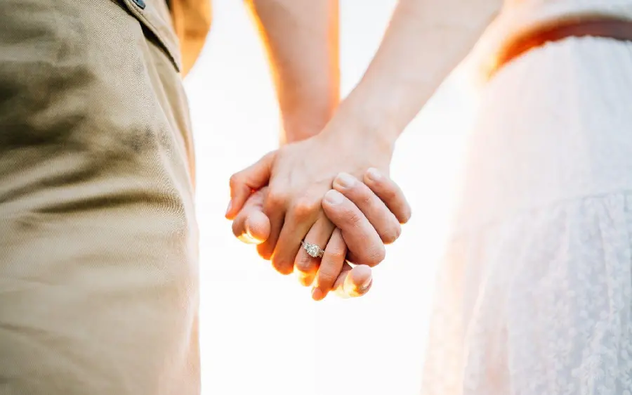 Profile photo of all bride and groom holding hands