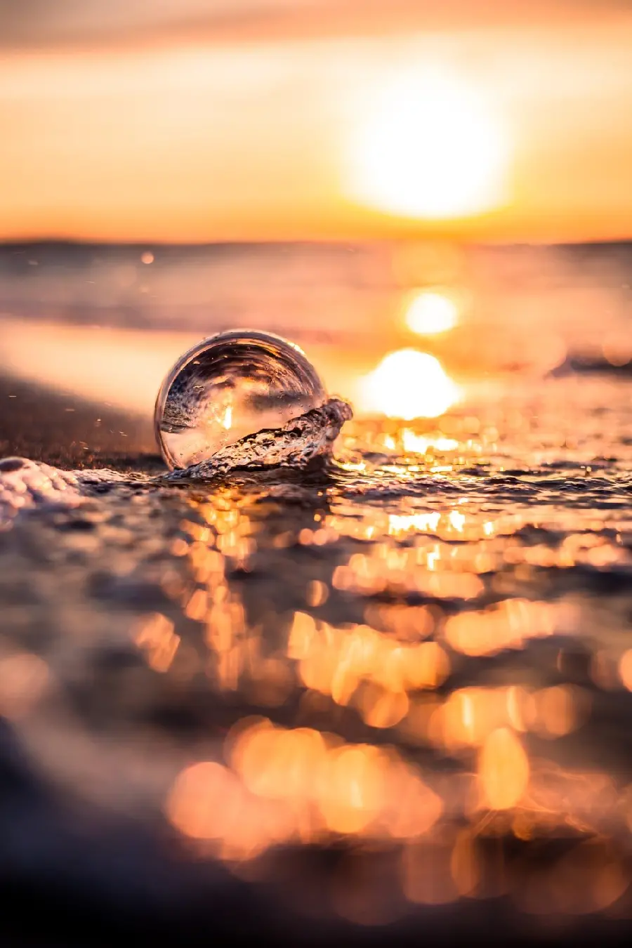 Glass bubble by the sea and sunset