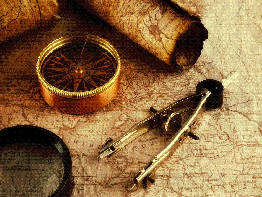 Image of an old compass and map next to a compass and a ruler