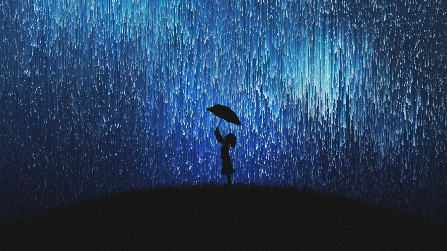 A photo suitable for a computer and laptop desktop of a shower of colored lights and a little girl with an umbrella