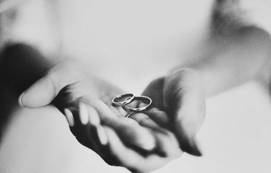 Bride and groom with black and white wedding rings